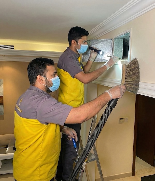 123 Our team performs detailed HVAC work by inspecting wall panels and using vacuum brushes for deep vent maintenance.