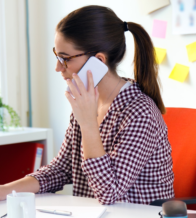 Portrait of beautiful young woman using her laptop in the office. Priority response for urgent repairs covered under your AMC plan.