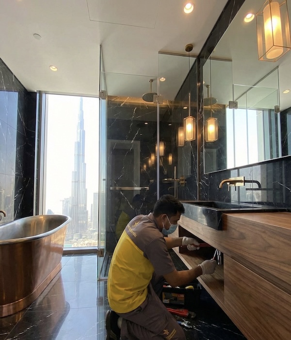 Detailed plumbing work on luxury vanity piping in a Dubai home using professional tools.