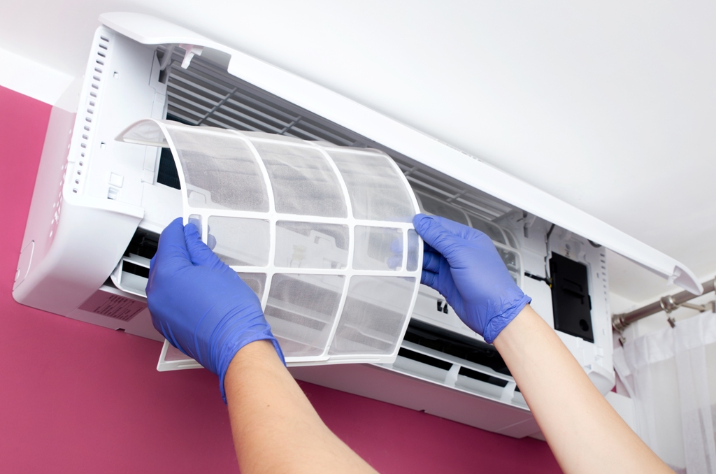 An Adams Care technician inspecting an air conditioner to ensure optimal performance and extend how long do AC units last