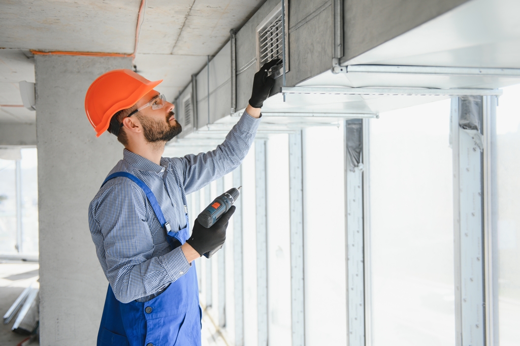 A man meticulously checking the heating and cooling system to avoid any air conditioner cleaning by Adams care